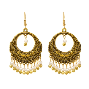 Bohemian hollow alloy drop earrings with white beads and vintage engraved fringe details