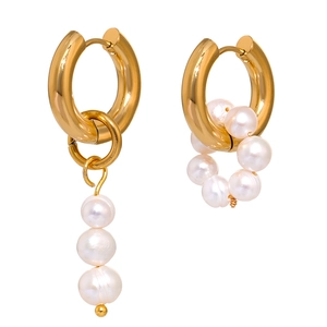 Asymmetric gold earrings with natural white freshwater pearls on a pure white background