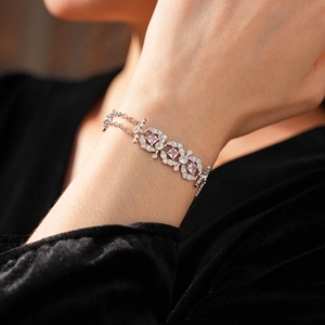 Close-up of a vintage bracelet with pink square gemstones and white zircon on wrist