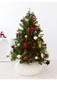 Detail of velvet Christmas ornaments in various shapes on a decorated festive tree