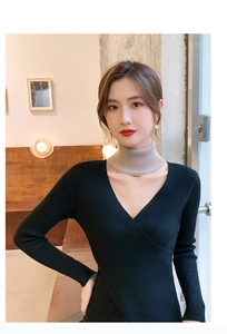 Detailed view of beige knitted high neck collar paired with a black V-neck knitted top