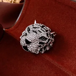 Vintage tiger head brooch with cubic zirconia inlay on a velvet background