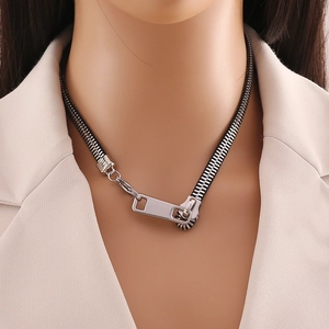 Unique black zipper pendant necklace with silver metal slider on minimalist beige suit