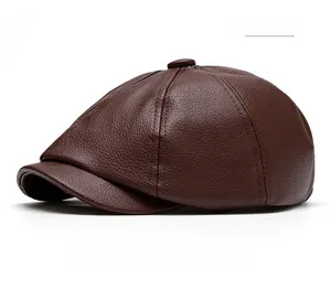 Close-up of coffee brown leather newsboy hat showing detailed litchi grain texture