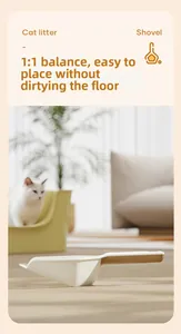 Cat litter shovel with 1:1 weight balance design stands upright on a modern clean floor