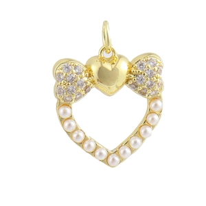 Detailed view of 18K gold plated heart pendant with zircon bow and pearl border