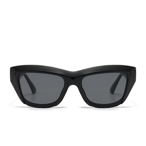 Modern avant-garde cat-eye sunglasses with thick black frames and dark grey lenses