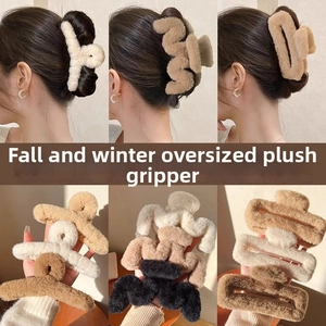 Detail of oversized plush hair claws in various earthy tones and textures for winter