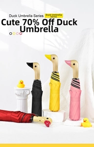 Detail of creative wooden duck head handles on colorful 3-fold sun and rain umbrellas