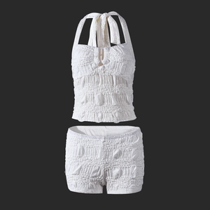 Detail of white two-piece halter set showing unique bubble textured fabric and ruched design