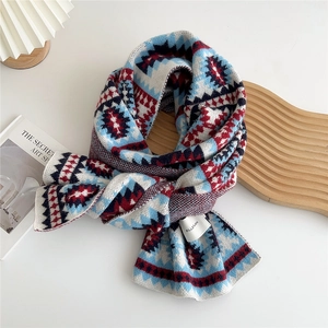 Detail of knitted scarf with geometric folk pattern and white woven brand label