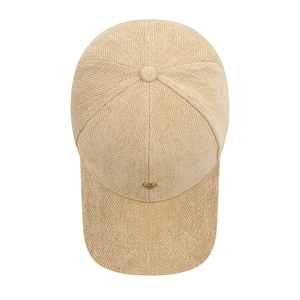 Stylish herringbone baseball cap in beige with a gold heart metal plate detail