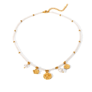 Detail of pearl necklace featuring gold flower pendants and adjustable lobster clasp closure