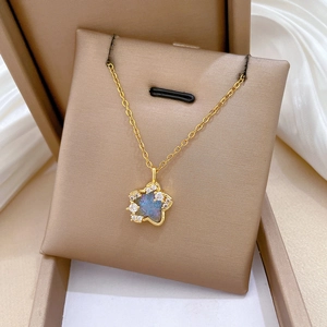 Close-up of star necklace with blue iridescent stone and diamonds in a jewelry box
