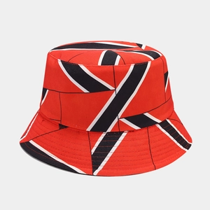 Detailed close-up of red bucket hat with black and white geometric diagonal stripes