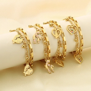 Detail of gold-plated layered heart bracelets for mothers on silk display stand