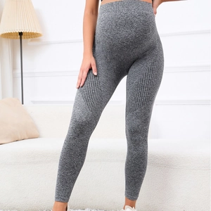 Grey high-waisted maternity leggings in seamless knit fabric shown on a model at home