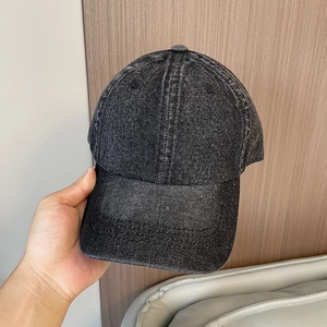 Close-up of vintage washed denim baseball cap with distressed texture and stitching