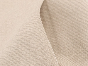 Close-up of beige linen fabric texture showing detailed weave of the blazer material