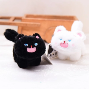 Funny black and white plush cat keychains with goofy expressions and fluffy fur