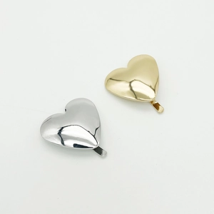 Minimalist heart shaped metal hair clips in gold and silver finish with a polished surface