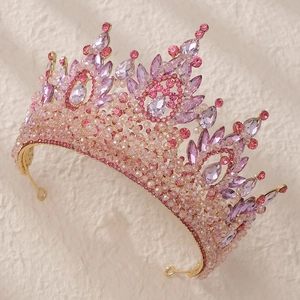 Macro detail of Baroque pink crystals and purple beads set on a golden crown base