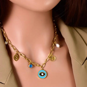 Bohemian gold chain necklace with blue evil eye pendants and white pearl detail