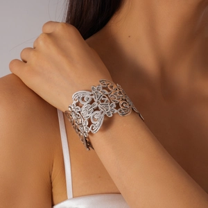 Detail of silver hollowed floral wide cuff bracelet with vintage bohemian patterns