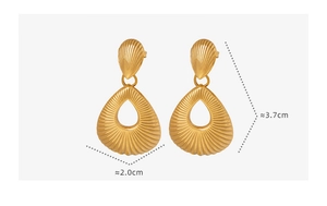 Detailed view of hollow teardrop earrings with radial texture and 18K gold finish