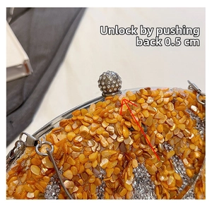 Detailed view of rhinestone sphere clasp and crystal-embellished oval evening bag