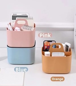 Detail of plastic desktop organizer with handle and compartments in pink, blue and orange