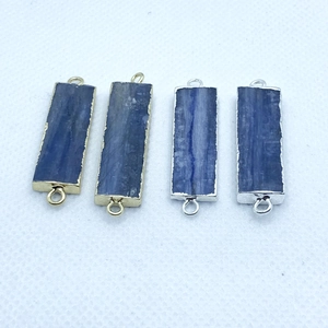 Detail of natural blue kyanite rectangular charms with gold and silver plated edges