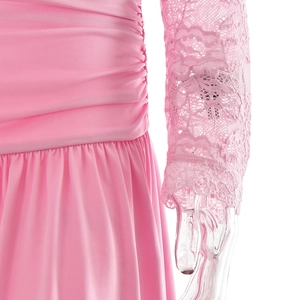 Detailed view of pink dress side ruching and delicate lace sleeves with scallop cuffs