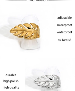 Detail of adjustable monstera leaf ring in gold and silver stainless steel finish