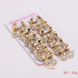 Close-up of heart-shaped crystal studded earrings set on a stainless steel card