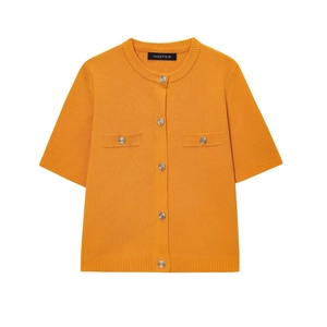 Detail of orange short-sleeve knit cardigan with silver embossed buttons and pockets