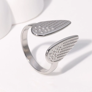 Macro detail of adjustable stainless steel ring featuring polished angel wing texture