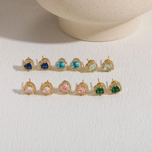Macro view of six colorful heart zircon earrings with 14K gold plating and diamond accents