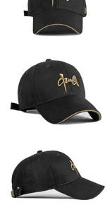 Detail of black baseball cap featuring gold calligraphy embroidery and adjustable strap