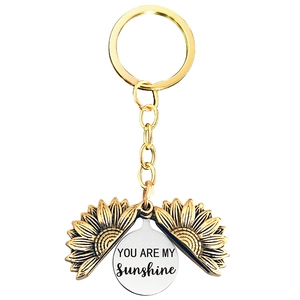 Detail of opening sunflower keychain with engraved YOU ARE MY SUNSHINE hidden message