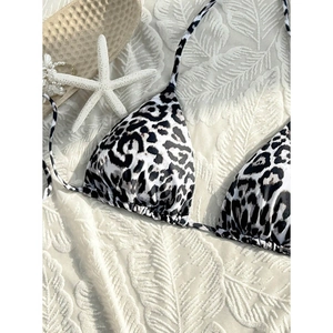 Detail of leopard print bikini top with halter neck ties and starfish beach decor
