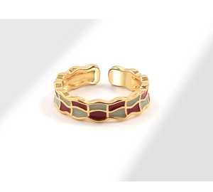Detailed view of adjustable gold-plated ring with red and green enamel checkered pattern