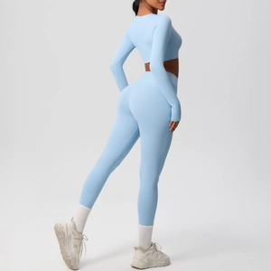 Detail of light blue yoga set featuring thumbhole cuffs and high-waist lifting leggings