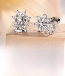 Macro view of rotating ferris wheel stud earring in silver titanium steel and zircon