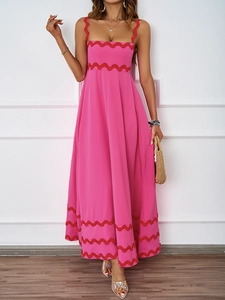 Detail of pink summer maxi dress showing layered red wave embroidery and square neckline