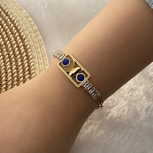 Golden stainless steel bracelet with blue enamel eye stones and sparkling cubic zirconia