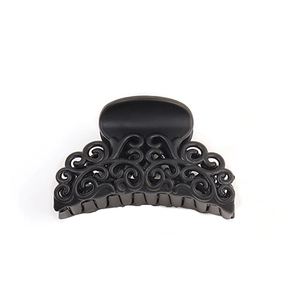 Matte black hollowed-out hair claw clip for women with elegant floral pattern on white background