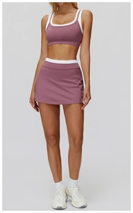 Detail of dry rose pink yoga skirt with white contrast waistband and ribbed texture fabric