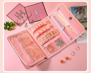 Detailed view of the pink folding jewelry organizer with specialized interior compartments