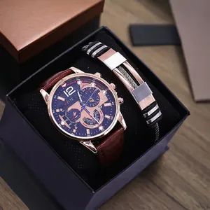 Detail of rose gold men's watch and black woven bracelet set in a black display gift box